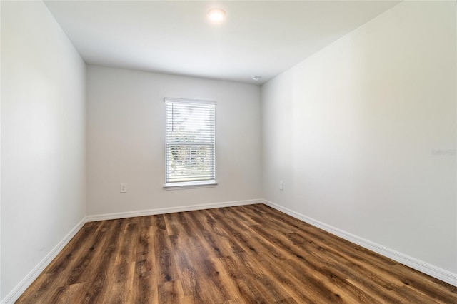 empty room with dark wood-type flooring