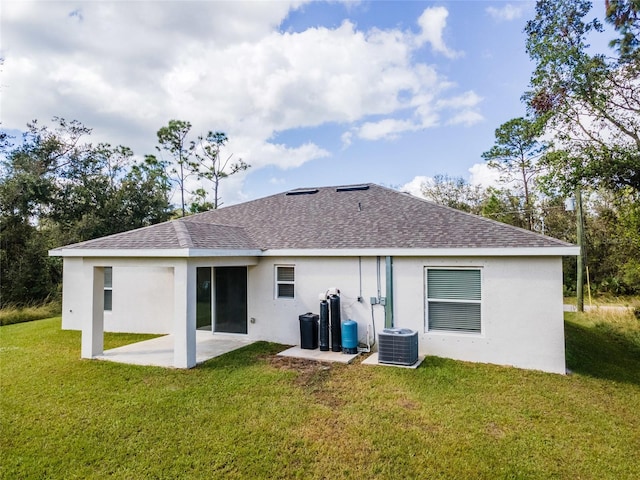 rear view of house featuring central AC, a patio area, and a yard