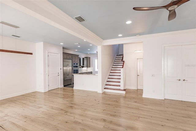 unfurnished living room with crown molding, light hardwood / wood-style flooring, and ceiling fan