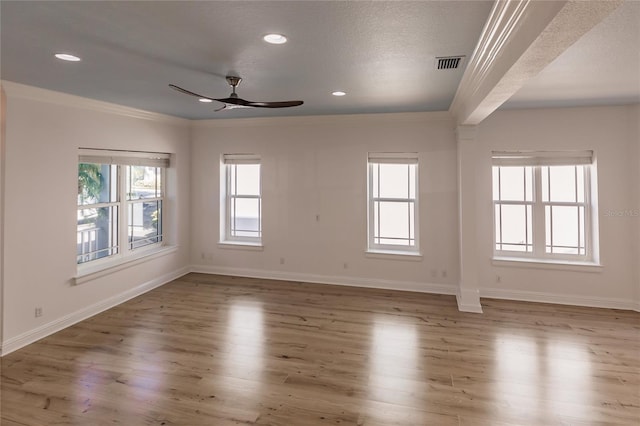 empty room featuring ceiling fan, crown molding, wood-type flooring, and a textured ceiling