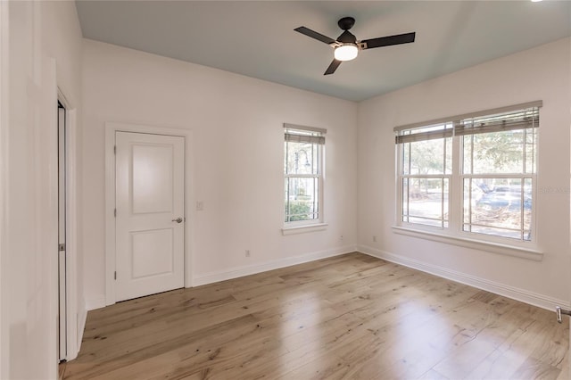 empty room featuring ceiling fan and light hardwood / wood-style flooring