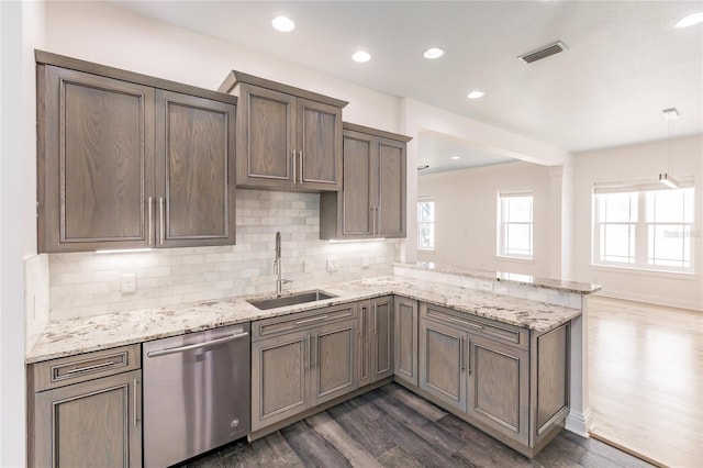 kitchen with dishwasher, sink, dark hardwood / wood-style floors, kitchen peninsula, and pendant lighting