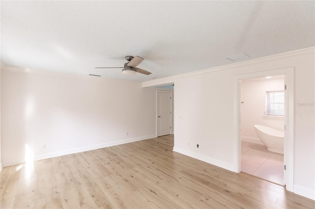 spare room with ceiling fan, light wood-type flooring, and ornamental molding