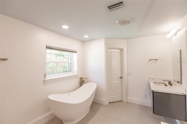 bathroom with tile patterned flooring, vanity, and a bathtub