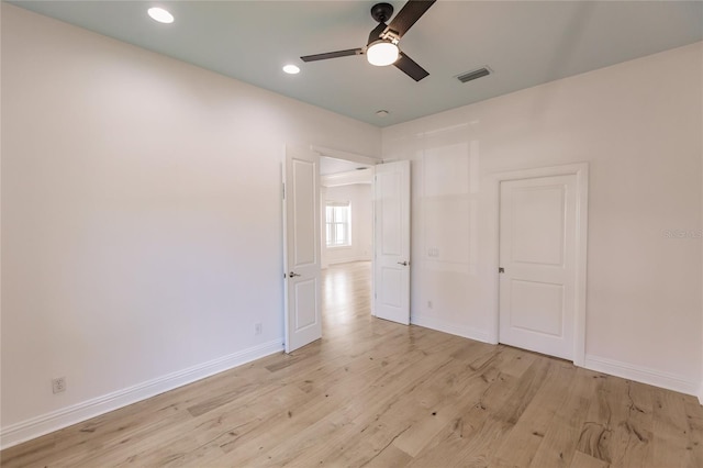 unfurnished bedroom with ceiling fan and light wood-type flooring