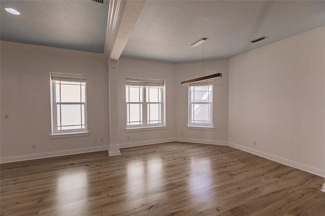 unfurnished room featuring beamed ceiling, a textured ceiling, and dark hardwood / wood-style flooring