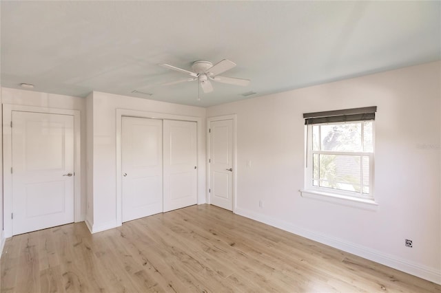 unfurnished bedroom with ceiling fan and light wood-type flooring