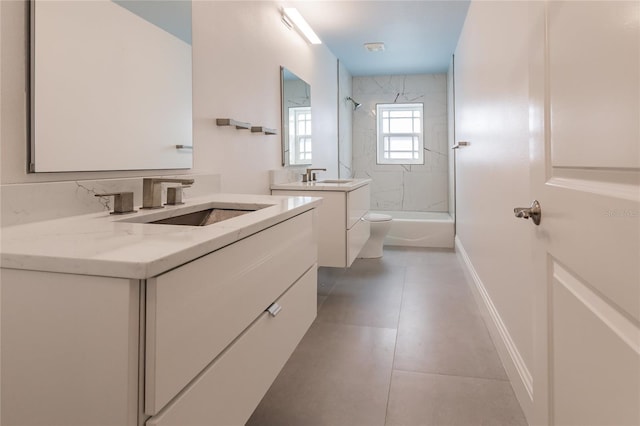 full bathroom with tile patterned flooring, vanity, tiled shower / bath combo, and toilet