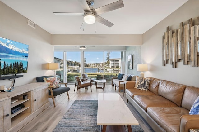 living room featuring ceiling fan and light wood-type flooring