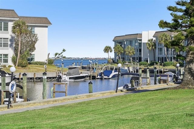 view of dock featuring a yard and a water view