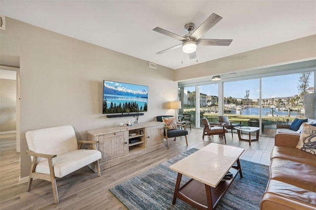 living room featuring ceiling fan and wood-type flooring