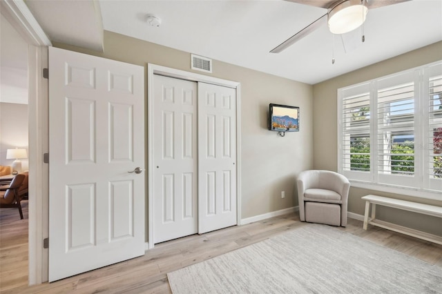 sitting room with ceiling fan and light hardwood / wood-style floors