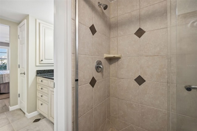 bathroom with tiled shower and vanity