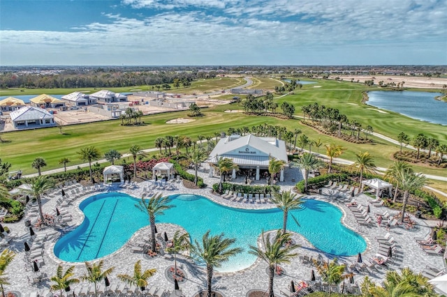 view of pool featuring a patio area and a water view