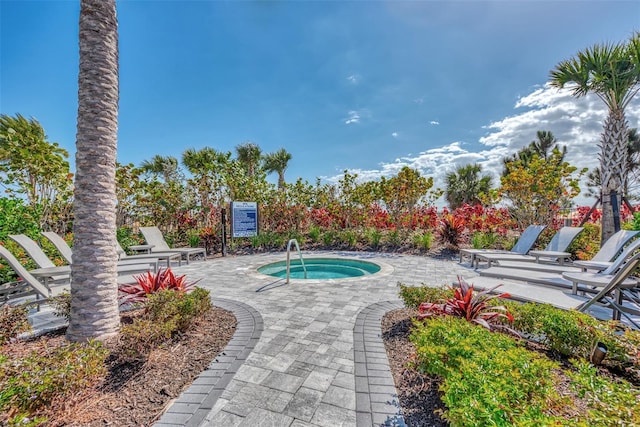 view of swimming pool with a community hot tub and a patio area