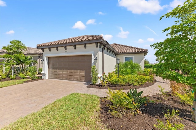 mediterranean / spanish home featuring a garage