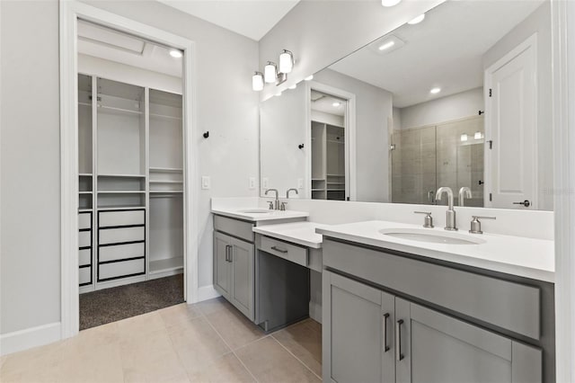 bathroom with tile patterned flooring, vanity, and walk in shower