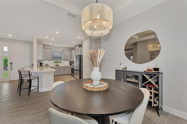 dining room featuring a chandelier and light hardwood / wood-style flooring