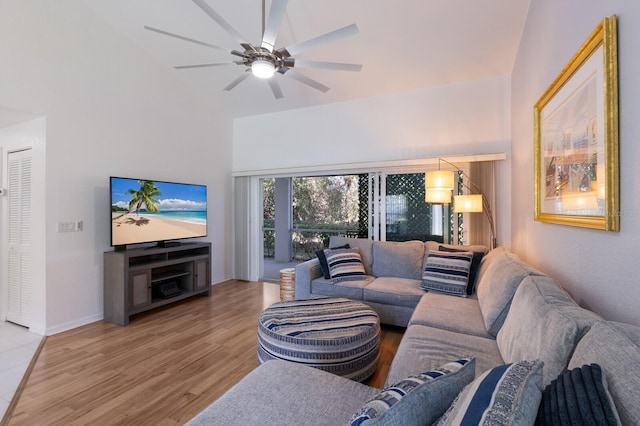 living room featuring light hardwood / wood-style floors, ceiling fan, and lofted ceiling