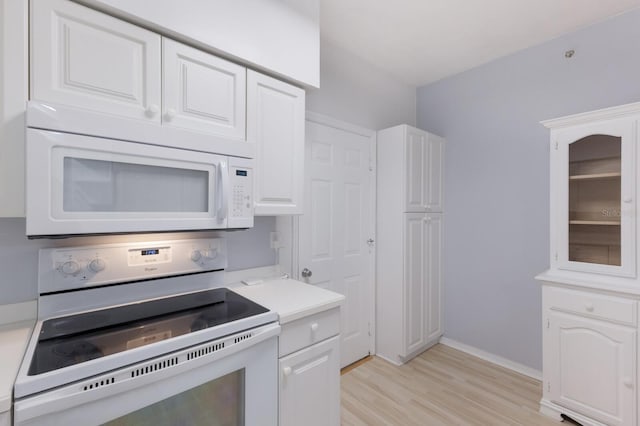 kitchen featuring electric stove, light hardwood / wood-style flooring, and white cabinets