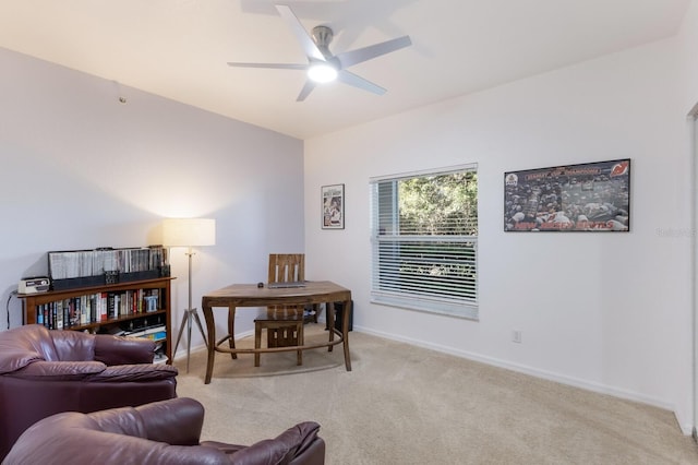 sitting room with ceiling fan and light colored carpet