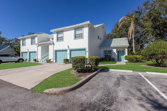 view of front of home with a garage and a front yard