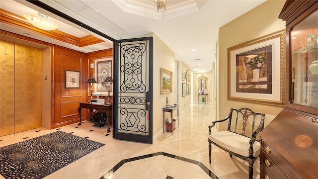 hallway featuring ornamental molding and a tray ceiling