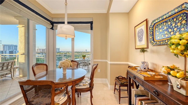 tiled dining room featuring ornamental molding