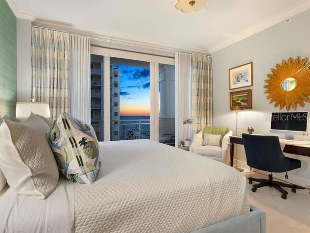 carpeted bedroom featuring access to outside and ornamental molding