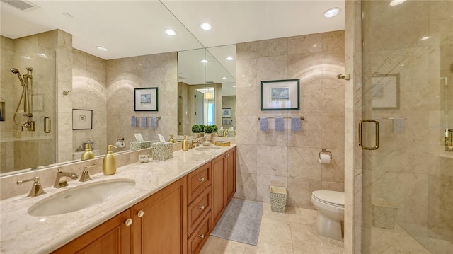 bathroom with vanity, an enclosed shower, tile walls, and toilet