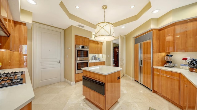 kitchen featuring paneled built in refrigerator, a warming drawer, stainless steel double oven, a raised ceiling, and light countertops