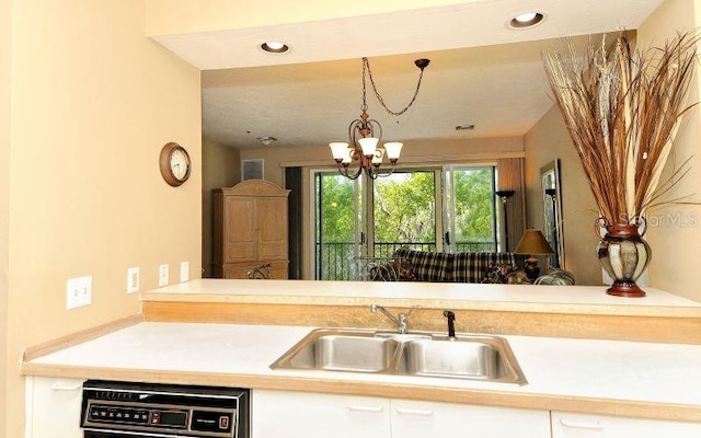 kitchen featuring decorative light fixtures, an inviting chandelier, and sink