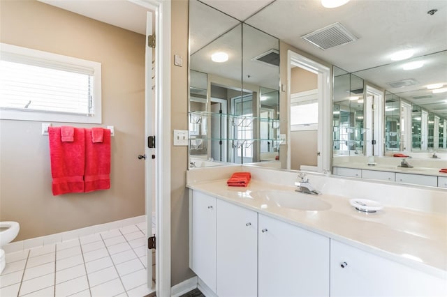 bathroom with tile patterned floors, a bidet, and vanity