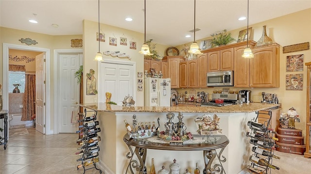 kitchen featuring a kitchen breakfast bar, stainless steel appliances, light stone counters, and pendant lighting