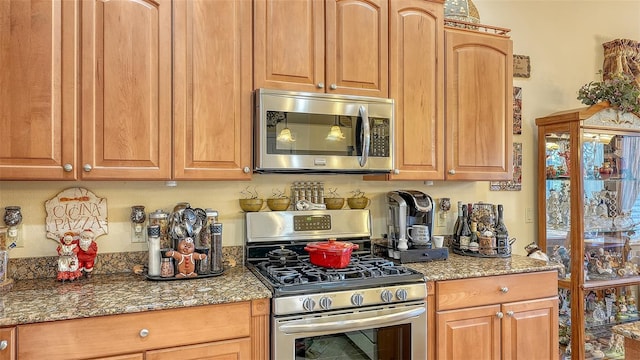 kitchen featuring stone countertops and appliances with stainless steel finishes