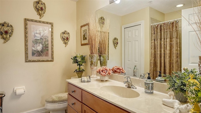 bathroom with vanity, a shower with shower curtain, and toilet