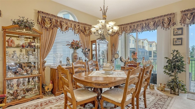 dining area featuring a healthy amount of sunlight and an inviting chandelier