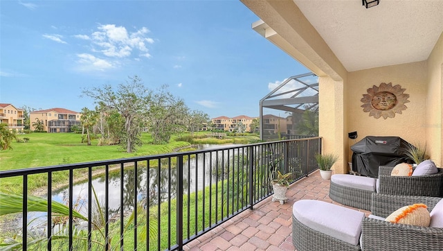 balcony featuring a water view and grilling area