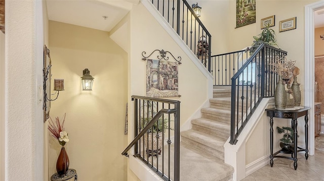 stairway with tile patterned floors