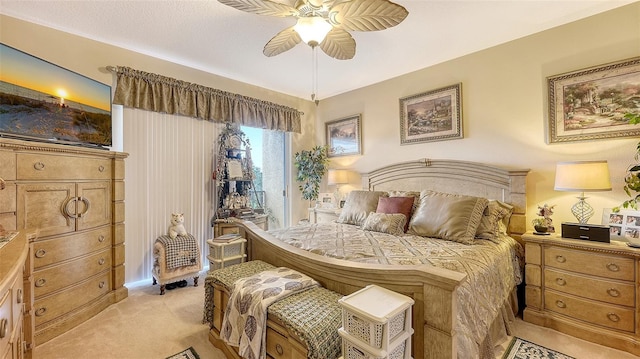 bedroom featuring light carpet and ceiling fan