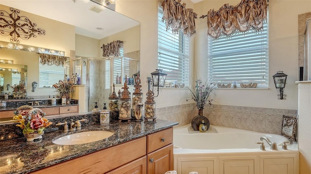 bathroom with separate shower and tub, vanity, and a healthy amount of sunlight