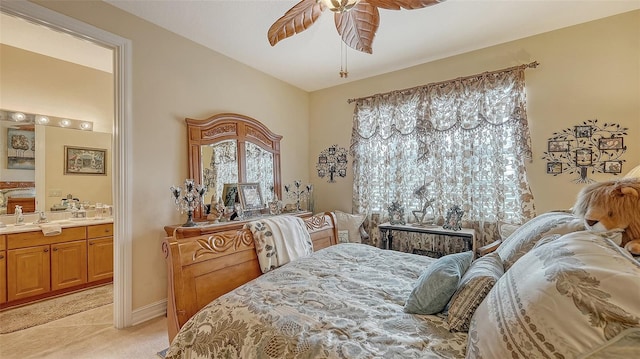 bedroom featuring ceiling fan, ensuite bathroom, and light carpet