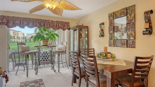 dining space featuring carpet and ceiling fan