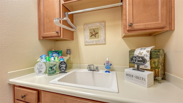 clothes washing area featuring sink