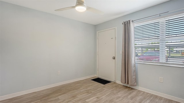 empty room with light hardwood / wood-style floors and ceiling fan