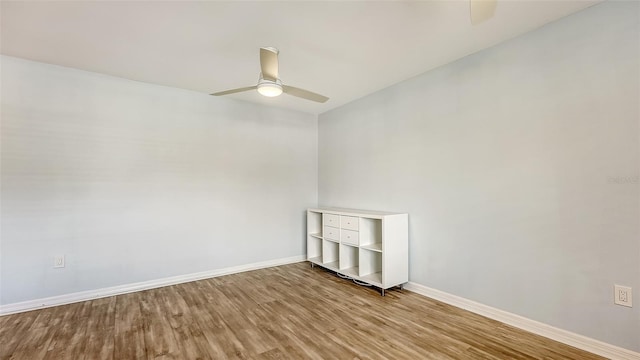 unfurnished room with ceiling fan and hardwood / wood-style floors