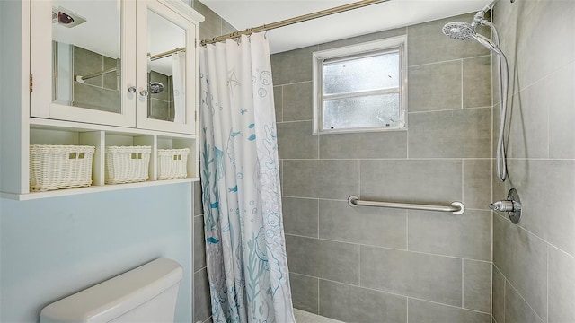 bathroom featuring toilet and walk in shower