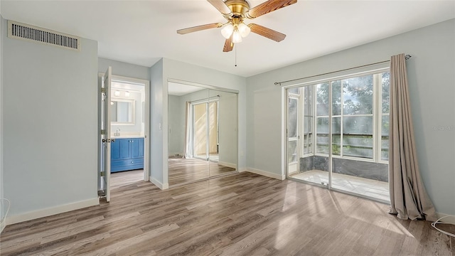 empty room with ceiling fan and wood-type flooring