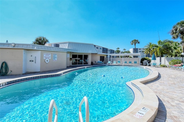 view of swimming pool with a patio area