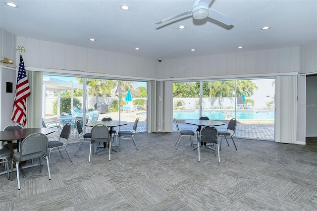 sunroom with a wealth of natural light and ceiling fan